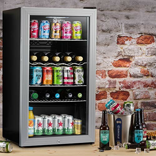 Mini fridge with assorted drinks against brick wall