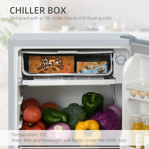 Open fridge with chiller box and vegetables inside.