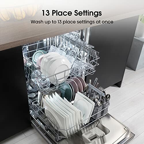 Open dishwasher with 13 place settings, including plates, bowls, and utensils.