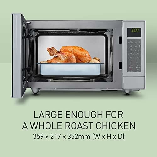Microwave oven with a whole roast chicken inside.