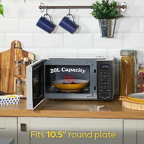Microwave oven with open door showing 20L capacity, placed on kitchen counter.