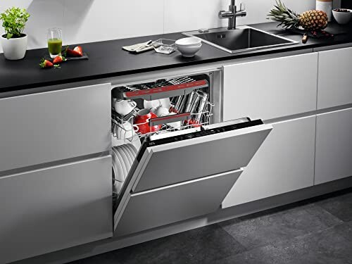 Open dishwasher in a modern kitchen with dishes inside.
