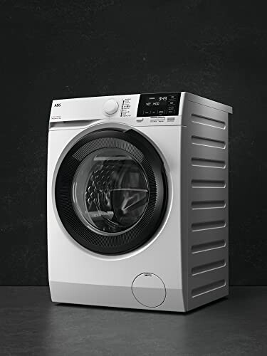 Modern front-loading washing machine against a dark background.