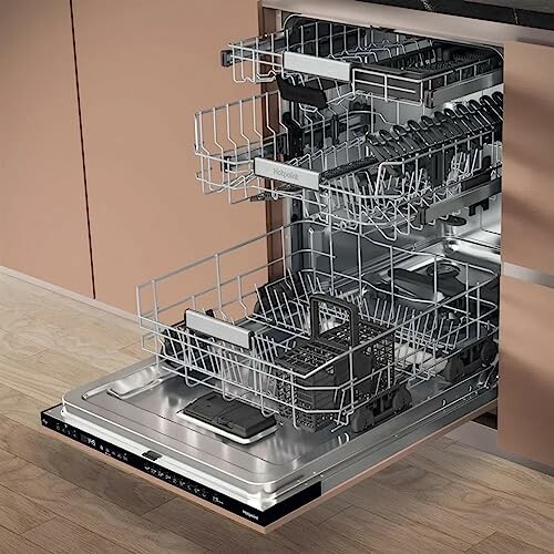 Open dishwasher with empty racks in modern kitchen