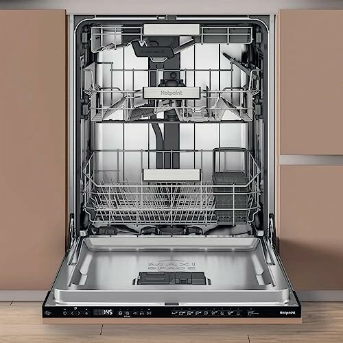 Open dishwasher with empty racks in a kitchen setting