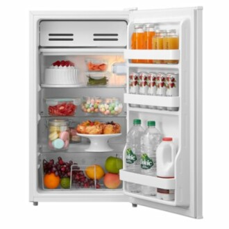 Open refrigerator filled with food and drinks, including fruits, desserts, and beverages.