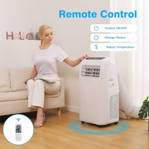 Woman using remote control with portable air conditioner in living room.