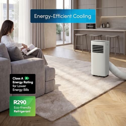 Woman sitting by portable air conditioner in modern living room.