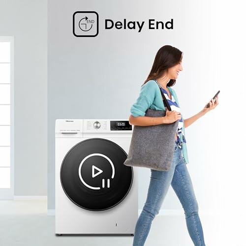 Woman using phone near washing machine with delay end feature.