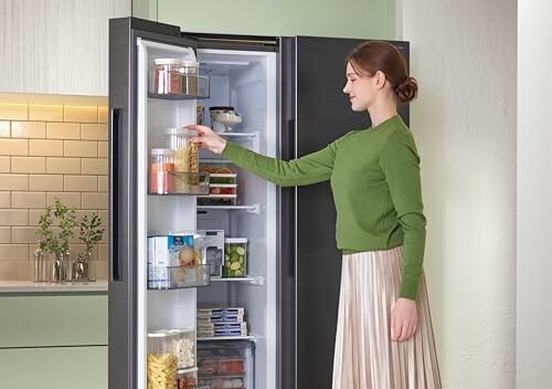 Woman organizing items in a refrigerator